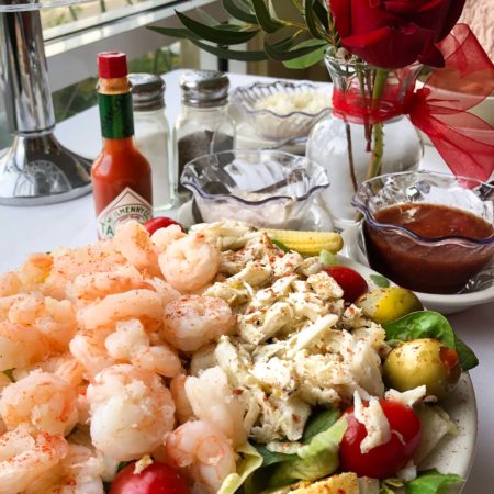 A cold glass of white wine is the perfect pairing for this classic seafood salad.