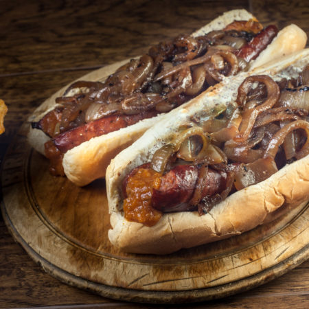 Beer-Braised Smoked Sausage Po’Boy with Griddled Vidalia Onions and Sauce Duo
