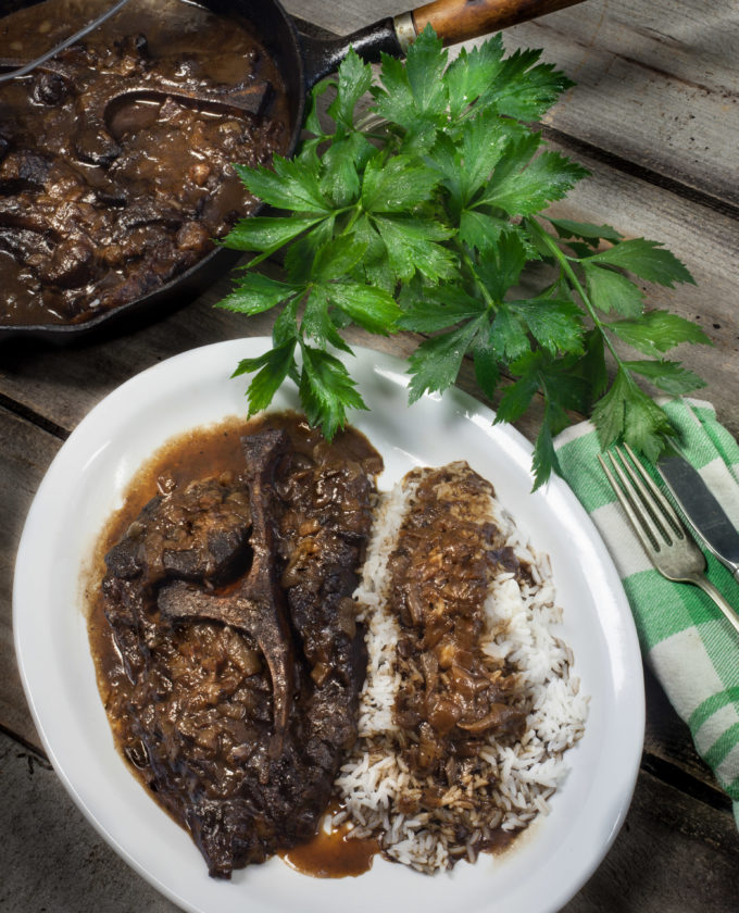 Smothered seven steak in onion gravy. Seven steak and gravy is traditional Cajun cooking.