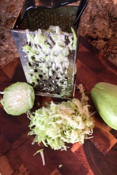 Mirliton are soft and easy to grate. No peeling necessary.