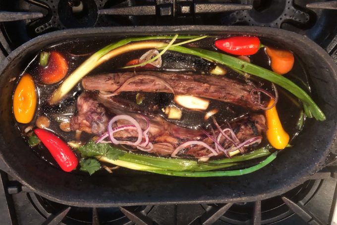 Cut the tail in half to fit your pot and cover the meat halfway with braising liquid.