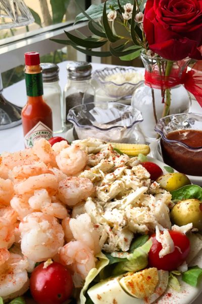 A cold glass of white wine is the perfect pairing for this classic seafood salad.